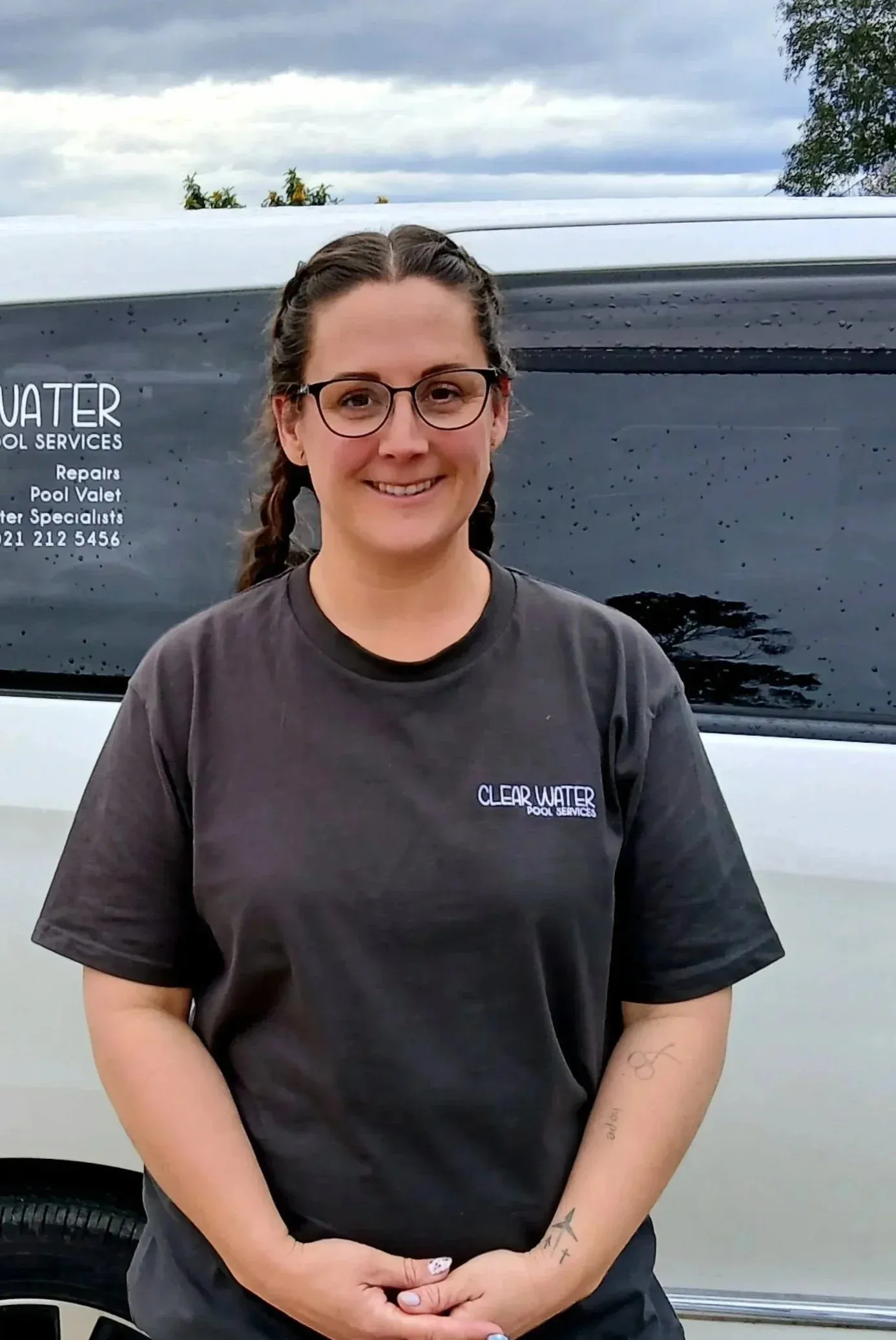 Gabrial Heath smiling in front of the Clear Water van.